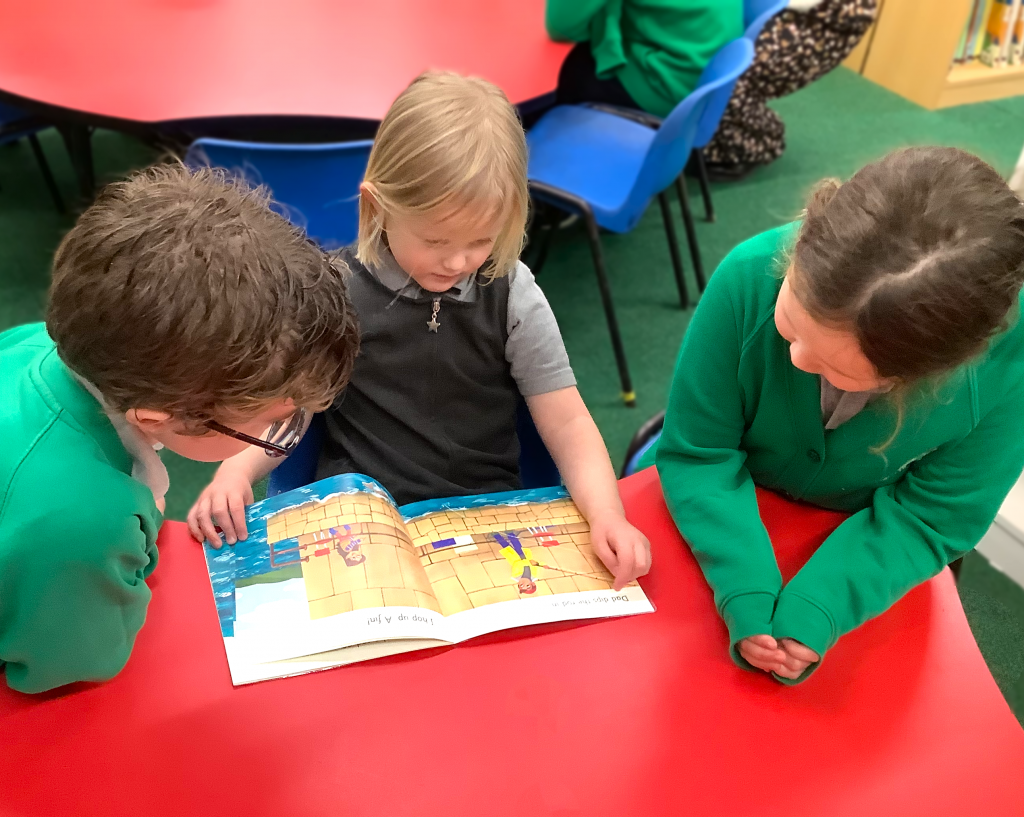 Children reading together in the "Buddy System"
